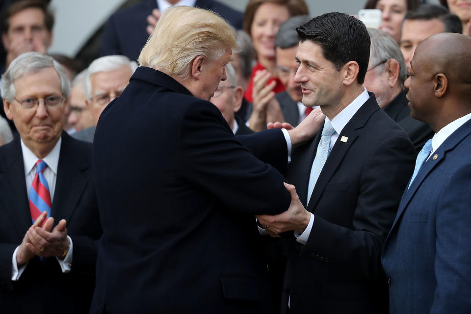 WASHINGTON, DC - DECEMBER 20:  U.S. President Donald Trump (2nd L) congratulates Speaker of the House Paul Ryan (R-WI) (C) during an event to celebrate Congress passing the Tax Cuts and Jobs Act with Senate Majority Leader Mitch McConnell (R-KY) (L) and other Republican members of the House and Senate on the South Lawn of the White House December 20, 2017 in Washington, DC. The tax bill is the first major legislative victory for the GOP-controlled Congress and Trump since he took office almost one year ago.  (Photo by Chip Somodevilla/Getty Images)