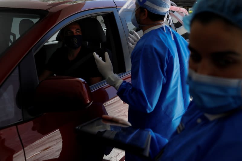 A plastic surgeon conducts drive-through Botox injections in the garage of his clinic in Miami