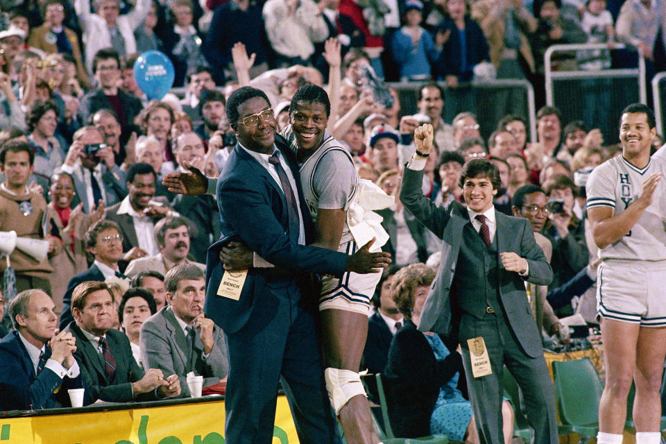 FILE - In this April 2, 1984, file photo, Georgetown head coach John Thompson, left, gives a happy pat to the most valuable player Patrick Ewing, after Georgetown defeated Houston 84-75 in Seattle. John Thompson, the imposing Hall of Famer who turned Georgetown into a “Hoya Paranoia” powerhouse and became the first Black coach to lead a team to the NCAA men’s basketball championship, has died. He was 78 His death was announced in a family statement Monday., Aug. 31, 2020. No details were disclosed.(AP Photo/File)