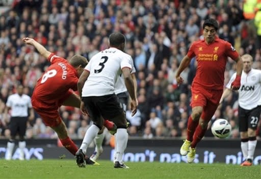 Liverpool's Steven Gerrard, left, scores against Manchester United during their English Premier League soccer match at Anfield in Liverpool, England, Sunday Sept. 23, 2012. (AP Photo/Clint Hughes)