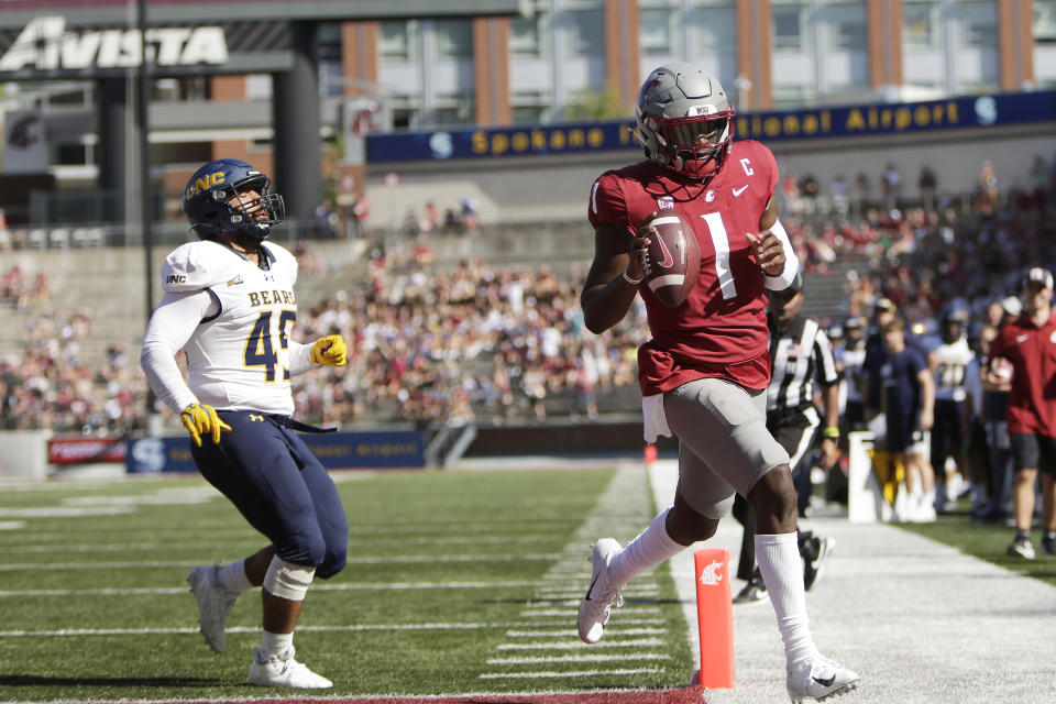 Washington State quarterback Cameron Ward (1) runs for a touchdown next to Northern Colorado linebacker Tama Tuitele during the first half of an NCAA college football game, Saturday, Sept. 16, 2023, in Pullman, Wash. (AP Photo/Young Kwak)