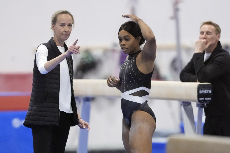 Gabby Douglas, right, talks with Anna Kotchneva during a break in competition at the American Classic Saturday, April 27, 2024, in Katy, Texas. (AP Photo/David J. Phillip)