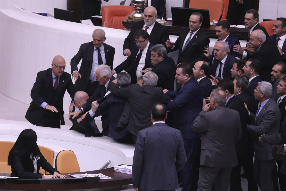 Lawmakers push earn other at the parliament, in Ankara, Turkey, Tuesday, Dec. 6, 2022. Huseyin Ors, a lawmaker from the opposition Good Party, was hospitalized on Tuesday following a brawl that broke out in Turkey's parliament during a tense debate over next year's budget. (AP Photo)