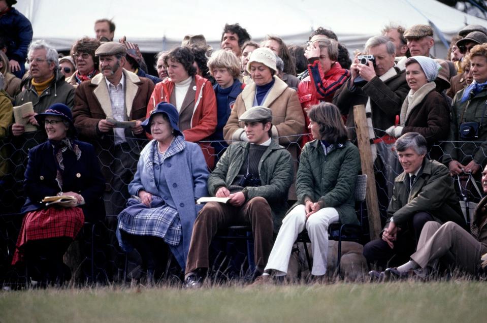 Lady Angela Oswald, the Queen Mother's Lady-in-Waiting, British Royal Queen Elizabeth The Queen Mother (1900-2002), and British Royal Prince Andrew and an unspecified woman sitting with a crowd of spectators in the background at the Badminton Horse Trials, held in the grounds of Badminton House, Badminton, Gloucestershire, England, April 1979.