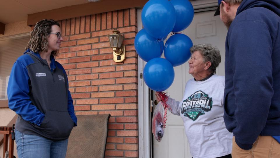 Robbins Heating & Air Conditioning Inc. owner Michelle Robbins, left, informs a local homeowner that she has been selected to receive a free furnace this year under the company's giveaway program.