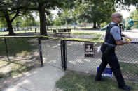 <p>An Alexandria, Va. police officer marks off a playground near the baseball field in Alexandria, Va., Wednesday, June 14, 2017, that was the scene of a shooting where House Majority Whip Steve Scalise of La., and others were shot during a congressional baseball practice. (Photo: Alex Brandon/AP) </p>