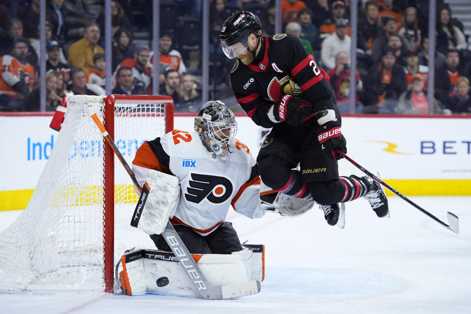 Ottawa Senators' Claude Giroux, right, leaps after deflecting the puck in front of Philadelphia Flyers' Felix Sandstrom during the third period of an NHL hockey game, Saturday, March 2, 2024, in Philadelphia. (AP Photo/Matt Slocum)
