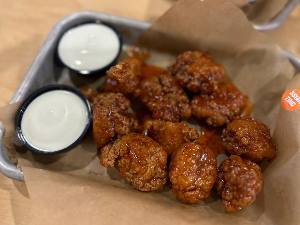 boneless wings with two cups of blue-cheese dipping sauce