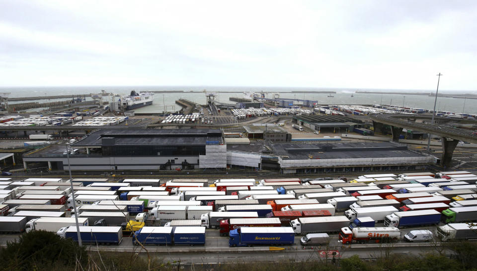 FILE - In this Tuesday March 12, 2019 file photo, lorries queue at the entrance to the Port of Dover ferry terminal during delays to the cross Channel ferry, in Dover, England. Britain unveiled a temporary tariff regime on Wednesday, March 13 that could boost the price of imports ranging from cars to butter if the U.K. leaves the European Union without an agreement on future trade, triggering fury among business leaders who weren't consulted on the proposals. The tariffs, which would last for up to 12 months, were published hours before lawmakers are scheduled to vote on whether to prevent the country from leaving the EU without a deal. (Gareth Fuller/PA via AP, file)