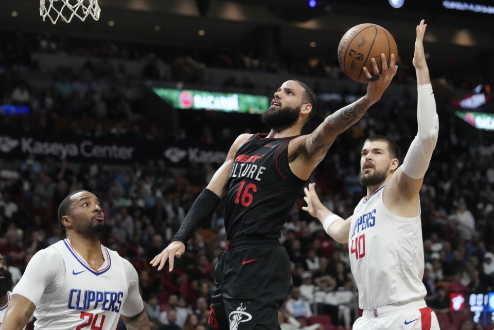 Miami Heat forward Caleb Martin (16) drives to the basket during the first half of an NBA basketball game against the LA Clippers, Sunday, Feb. 4, 2024, in Miami. (AP Photo/Marta Lavandier)