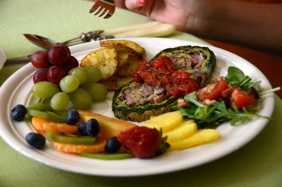 This Aug. 17, 2013 photo shows a breakfast plate at Le Plumard B&B in Levis, Quebec. A bicycle ride from Levis east along the St. Lawrence River takes cyclists through a succession of quiet villages along the river. (AP Photo/Calvin Woodward)
