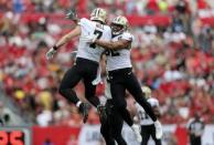 Dec 9, 2018; Tampa, FL, USA; New Orleans Saints quarterback Taysom Hill (7) and linebacker Craig Robertson (52) celebrate after a blocked punt during the second half against the Tampa Bay Buccaneers at Raymond James Stadium. Kevin Jairaj-USA TODAY Sports