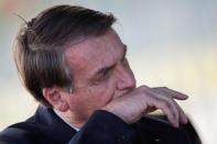 Brazil's President Jair Bolsonaro gestures while meets supporters as he leaves Alvorada Palace, as the spread of coronavirus disease (COVID-19) continues, in Brasilia