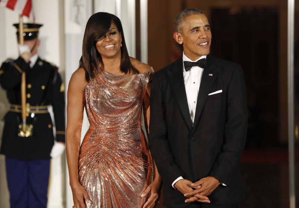 In this photo taken Oct. 18, 2016, President Barack Obama and first lady Michelle Obama waits to greet Italian Prime Minister Matteo Renzi and his wife Agnese Landini on the North Portico for a State Dinner at the White House in Washington. What does Michelle Obama do next? After eight years as a high-profile advocate against childhood obesity, a sought-after talk show guest, a Democratic power player and a style maven, the first lady will have her pick of options when she leaves the White House next month. (AP Photo/Pablo Martinez Monsivais)