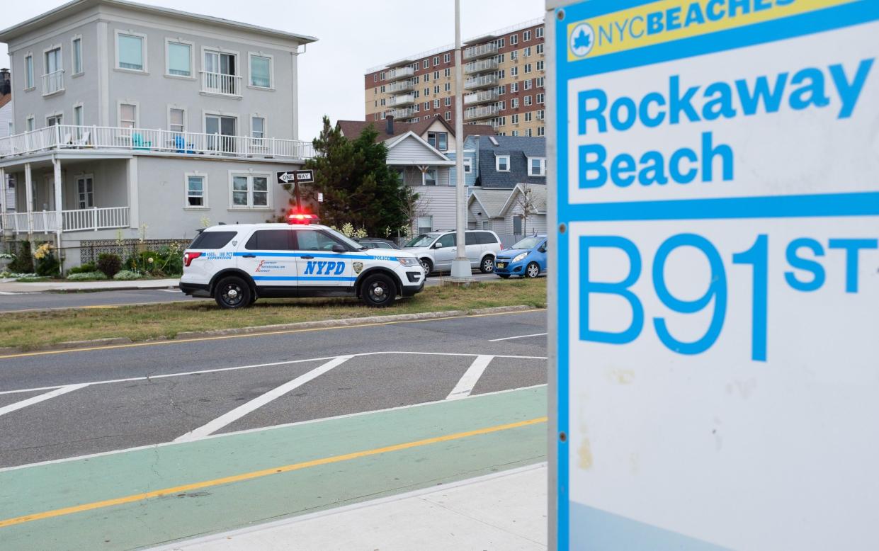 The woman was bitten on her left leg and taken from Rockaway Beach to hospital