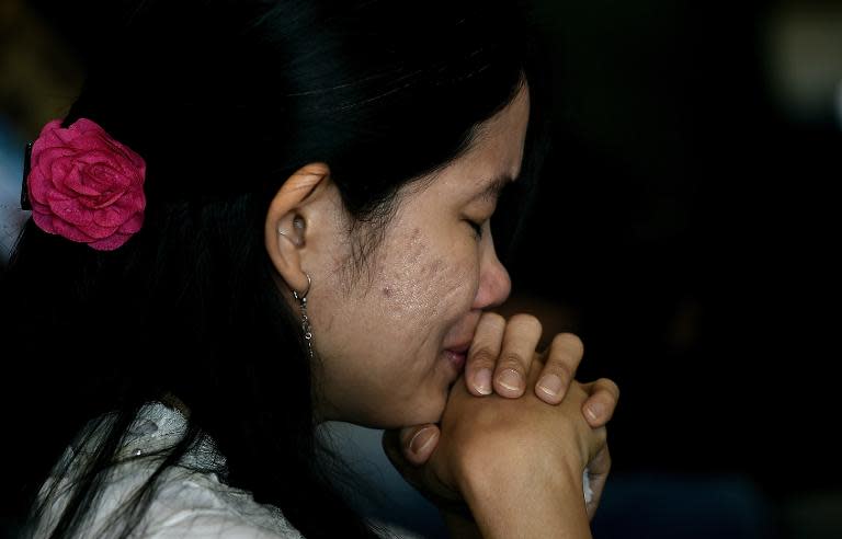 A family member of a passenger onboard missing Malaysian air carrier AirAsia flight QZ8501 reacts during a briefing session at the crisis-centre set up at Juanda International Airport in Surabaya, on December 30, 2014