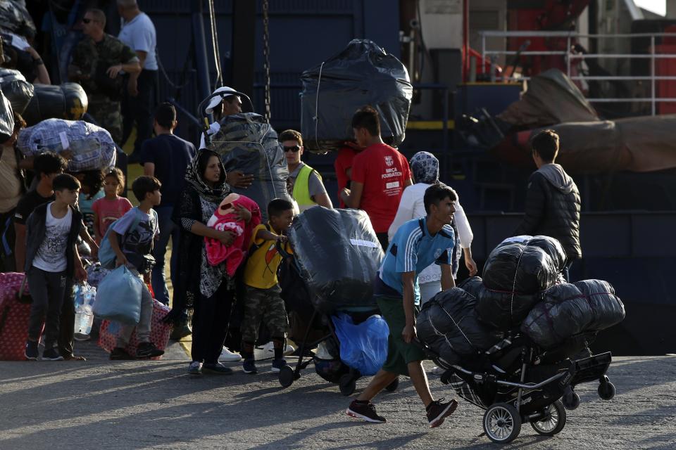 Refugees and migrants arrive at the port of Thessaloniki, northern Greece, Monday, Sept. 2, 2019. About 1,500 asylum-seekers were being transported from Greece's eastern Aegean island of Lesbos to the mainland Monday as part of government efforts to tackle massive overcrowding in refugee camps and a recent spike in the number of people arriving from the nearby Turkish coast. (AP Photo/Giannis Papanikos)