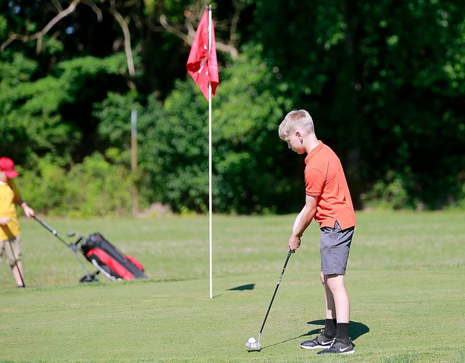 Clayton Moravy putts on one of the range holes at the Brookside Junior Golf program that is celebrating it's 50th year this year on Monday, June 27, 2022. TOM E. PUSKAR/ASHLAND TIMES-GAZETTE