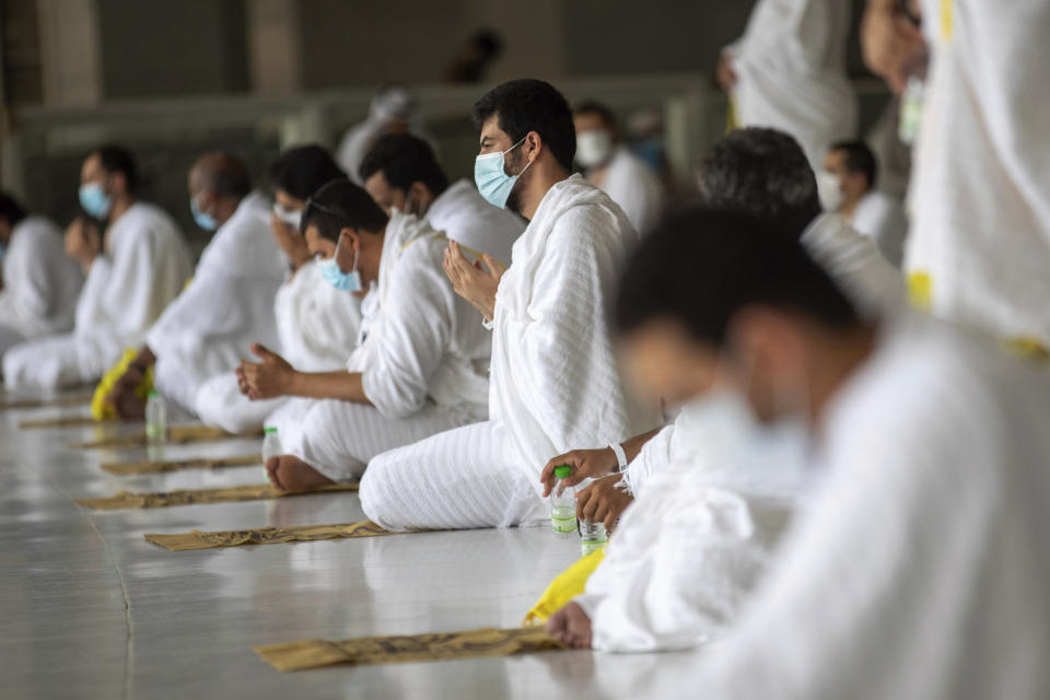 In this photo released by the Saudi Media Ministry, a limited numbers of pilgrims pray in the first rituals of the hajj, as they keep social distancing to limit exposure and the potential transmission of the coronavirus, at the Grand Mosque in the Muslim holy city of Mecca, Saudi Arabia, Wednesday, July 29, 2020. A unique and scaled-down hajj started on Wednesday. (Saudi Media Ministry via AP)