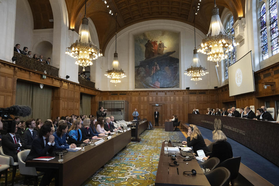 The Syrian government legal delegation, empty seats, rear, did not attend preliminary hearings opened in a case in which the Netherlands and Canada, left, table, are suing Syria at the International Court of Justice, or World Court, the United Nations' highest judicial organ, in The Hague, Netherlands, Tuesday, Oct. 10, 2023, accusing Damascus of massive human rights violations against its own people. (AP Photo/Peter Dejong)