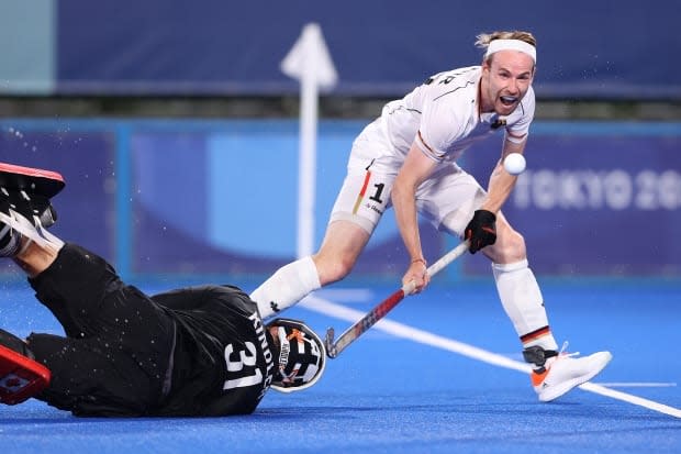 Germany's Christopher Rühr beats a sprawling Antoni Kindler as part of a 7-1 rout of the Canadians. (Alexander Hassenstein/Getty Images - image credit)