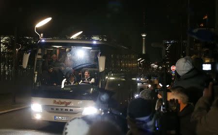 A bus with refugees arrives from the Bavarian town of Landshut to the Chancellery building in Berlin, Germany, January 14, 2016. REUTERS/Fabrizio Bensch