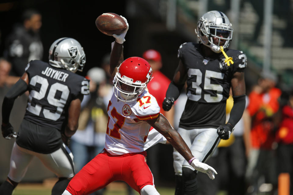 Kansas City Chiefs wide receiver Mecole Hardman (17) celebrates after scoring a touchdown during the first half of an NFL football game against the Oakland Raiders Sunday, Sept. 15, 2019, in Oakland, Calif. At left is Oakland Raiders free safety Lamarcus Joyner (29) and free safety Curtis Riley (35). (AP Photo/D. Ross Cameron)