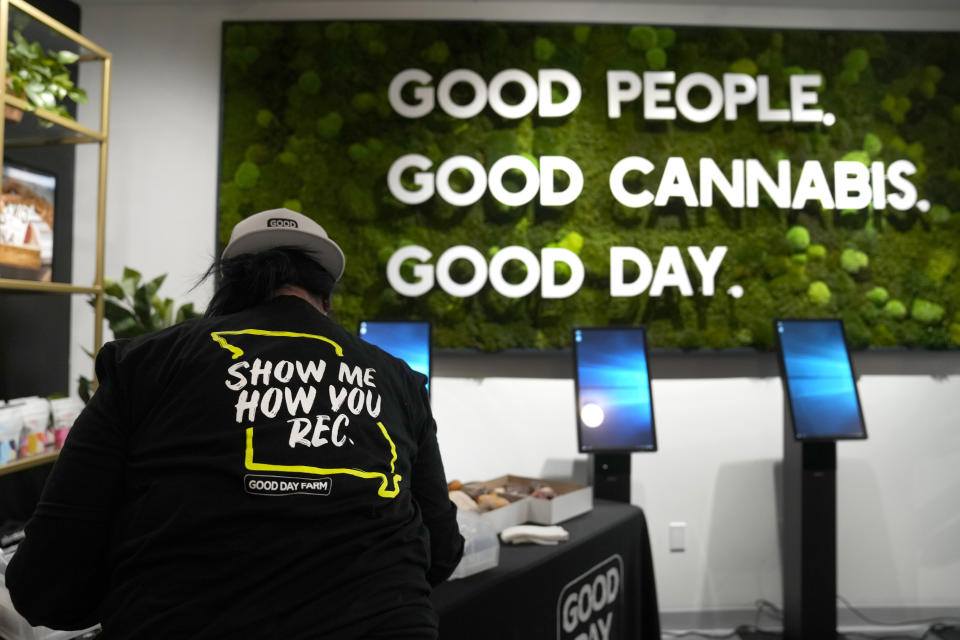 Assistant manager Mandy Gratz arranges a display at Good Day Farm dispensary Friday, Feb. 3, 2023, in St. Louis. Recreational marijuana sales were allowed to begin on Friday in Missouri after the state's health department gave approval. (AP Photo/Jeff Roberson)