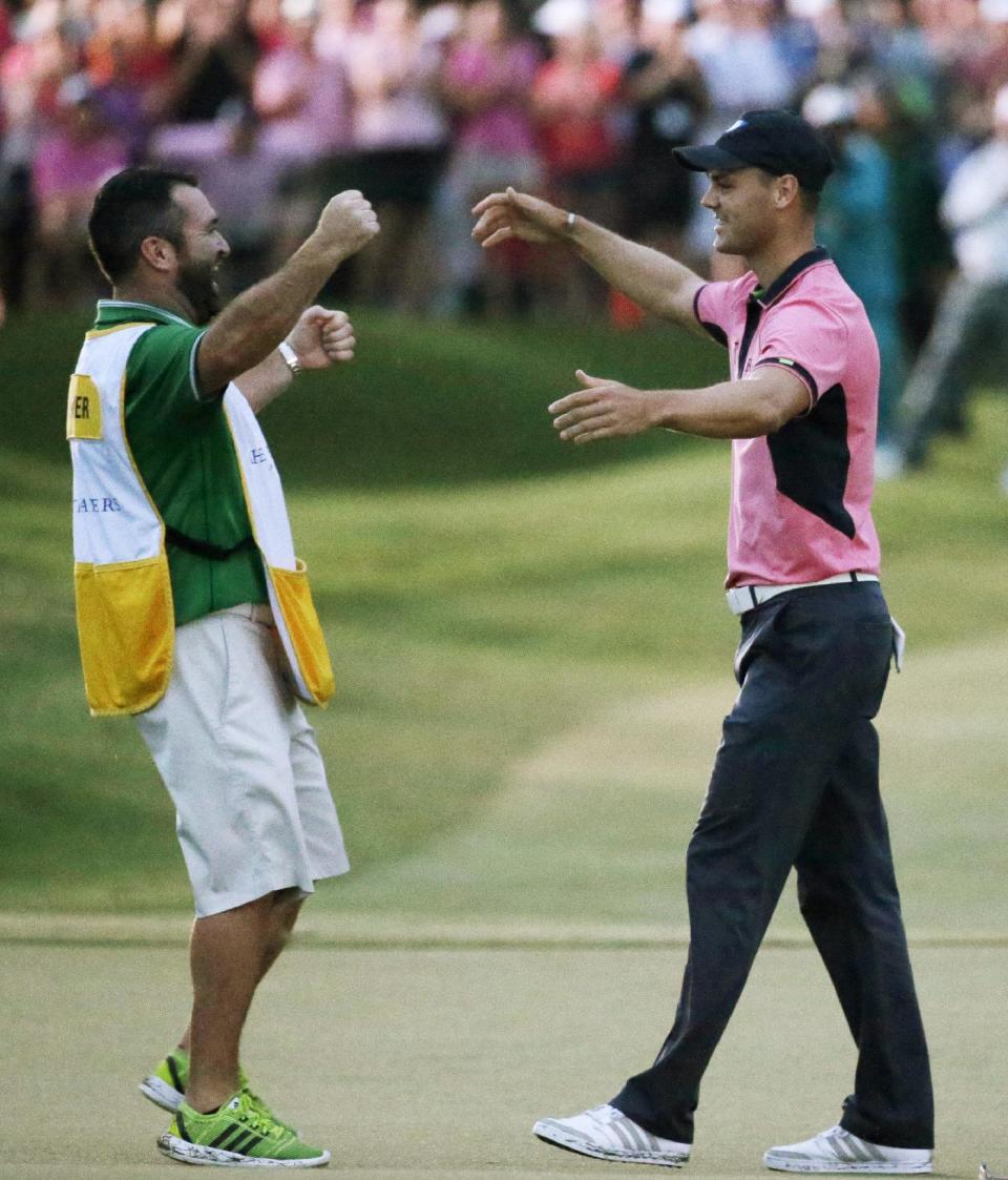 Martin Kaymer of Germany, left, celebrates with his caddie Craig Connelly after winningThe Players championship golf tournament at TPC Sawgrass, Sunday, May 11, 2014 in Ponte Vedra Beach, Fla. (AP Photo/John Raoux)