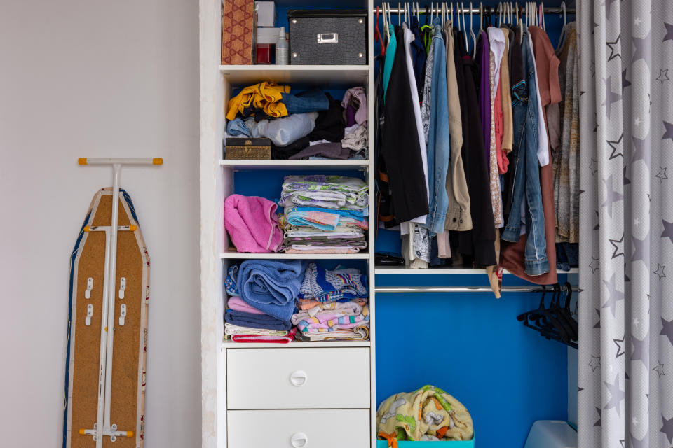 To start cleaning you closet, begin by sorting clothes into three piles: donate, repair and keep.&nbsp; (Photo: Madhourse via Getty Images)