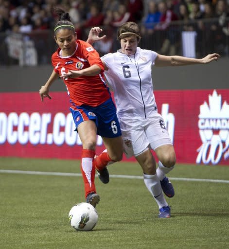 Carol Sanchez (L) of Costa Rica and Amy LePeilbet of the United States battle for the ball during the first half of semifinals action of the 2012 CONCACAF Women's Olympic Qualifying Tournament at BC Place, on January 27, in Vancouver, British Columbia, Canada. The USA won 3-0