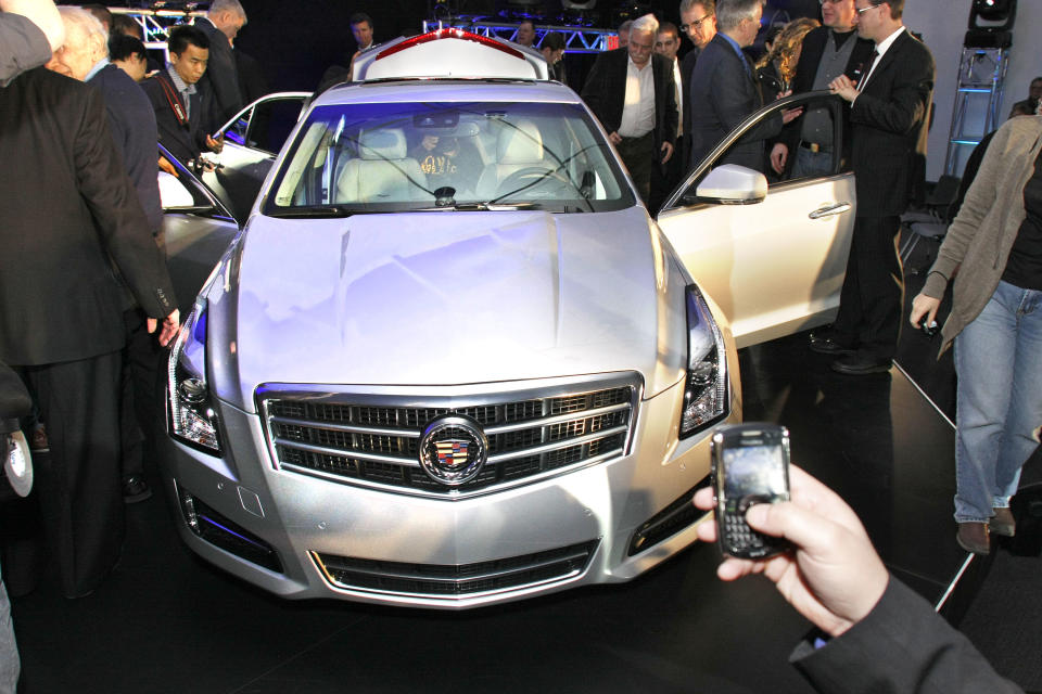 DETROIT, MI - JANUARY 8: Invited journalists examine the 2013 Cadillac ATS luxury sedan after its world premiere at the College for Creative Studies on the eve of the 2012 North American International Auto Show January 8, 2012 in Detroit, Michigan. The NAIAS at Detroit's Cobo Hall opens to the public January 14th and continues through January 22nd. (photo by Bill Pugliano/Getty Images)