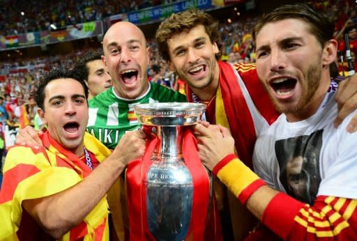 (From L) Spanish midfielder Xavi Hernandez, Spanish goalkeeper Pepe Reina, Spanish forward Fernando Llorente and Spanish defender Sergio Ramos pose with the trophy after winning the Euro 2012 football championships final match Spain vs Italy at the Olympic Stadium in Kiev. Spain won 4-0