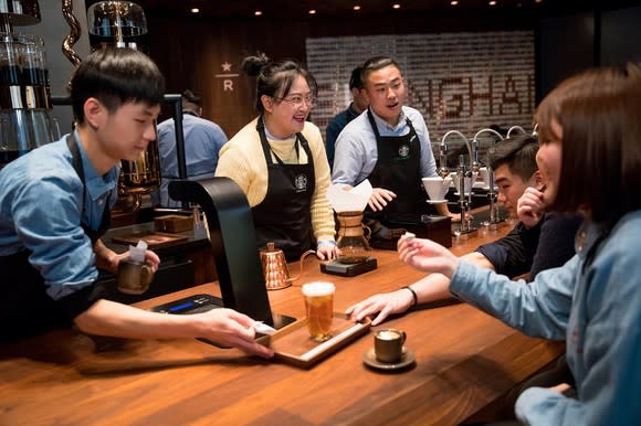 Starbucks employees serve customers in the Shanghai Roastery.