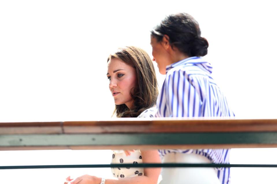 <p>Kate wore a blue and white polka-dot dress. <a rel="nofollow noopener" href="https://www.townandcountrymag.com/style/fashion-trends/a22145209/kate-middleton-polka-dot-dress-wimbledon-2018-photos/" target="_blank" data-ylk="slk:More info on her whole outfit here.;elm:context_link;itc:0;sec:content-canvas" class="link ">More info on her whole outfit here.</a></p>