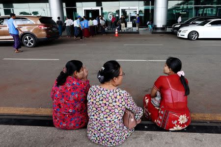 Women sit near the taxi stand in front of exit 6 at Yangon International Airport, where Ko Ni was murdered, in Yangon, Myanmar, October 18, 2018. REUTERS/Ann Wang/Files