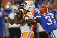 Tennessee quarterback Hendon Hooker (5) is stopped by Florida defensive lineman Princely Umanmielen (33) during the first half of an NCAA college football game, Saturday, Sept. 25, 2021, in Gainesville, Fla. (AP Photo/John Raoux)