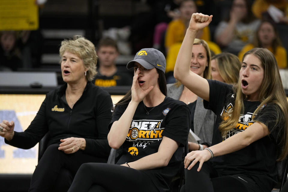 Iowa coach Lisa Bluder, left, guard Caitlin Clark and guard Kate Martin, right, react to fans during an Iowa women's basketball team celebration Wednesday, April 10, 2024, in Iowa City, Iowa. Iowa lost to South Carolina in the college basketball championship game of the women's NCAA Tournament on Sunday. (AP Photo/Charlie Neibergall)