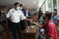 Bangkok governor independent candidate Asawin Kwanmuang, front left, introduces himself during an election campaign in Bangkok, Thailand, Tuesday, May 17, 2022. Residents of the Thai capital Bangkok will cast their ballots for the city’s leader Sunday in a vote seen as a barometer of the public mood ahead of an approaching general election. (AP Photo/Sakchai Lalit)