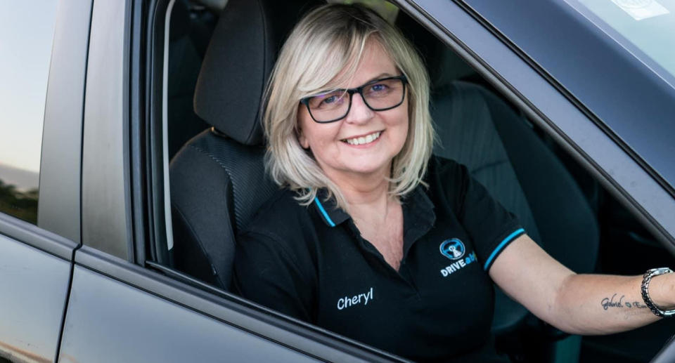 Cheryl York sits behind the wheel of a car.