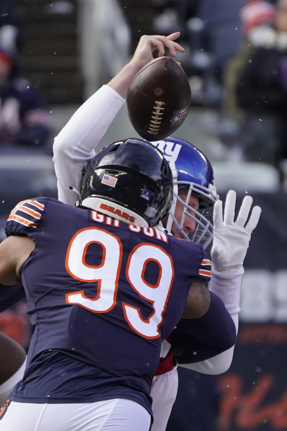 Chicago Bears outside linebacker Trevis Gipson (99) hits New York Giants quarterback Mike Glennon causing a fumble, during the first half of an NFL football game Sunday, Jan. 2, 2022, in Chicago. (AP Photo/Charles Rex Arbogast)