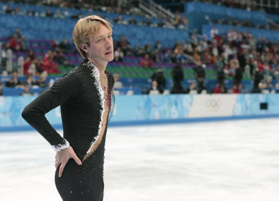 Evgeni Plushenko of Russia leaves the ice after pulling out of the men's short program figure skating competition due to illness at the Iceberg Skating Palace during the 2014 Winter Olympics, Thursday, Feb. 13, 2014, in Sochi, Russia. (AP Photo/Ivan Sekretarev)
