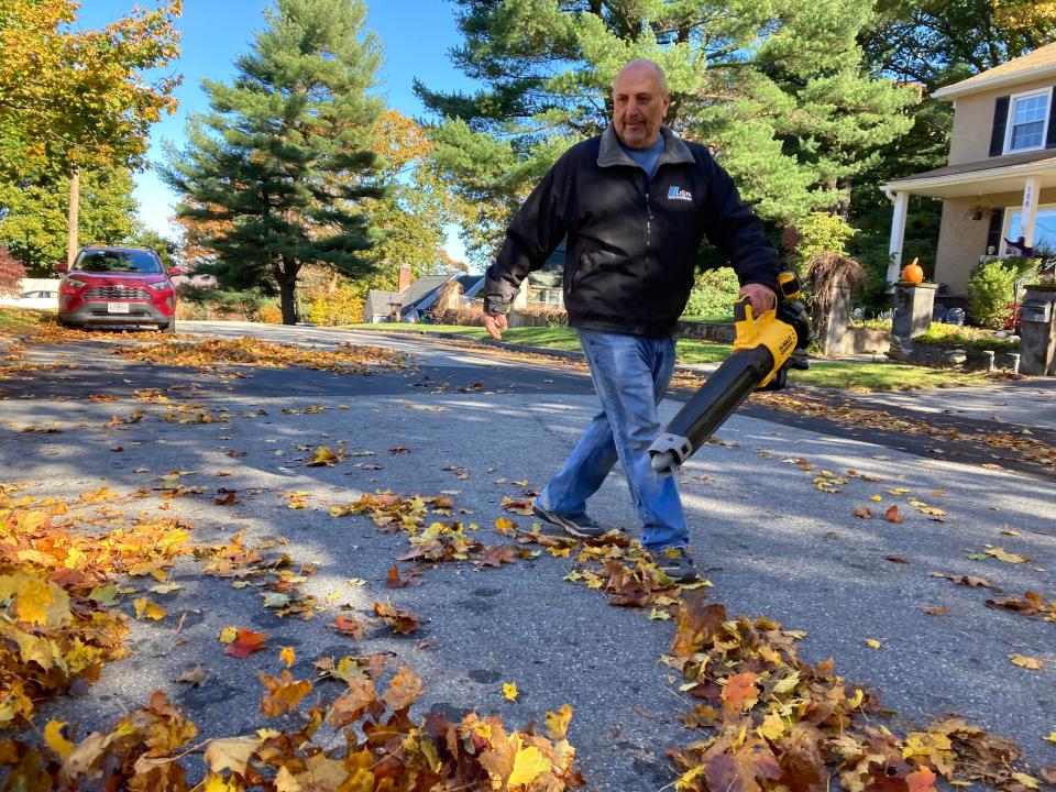 Ricky Boyer using his electric leaf blower.