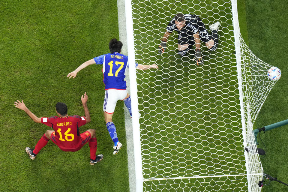 Japan's Ao Tanaka, center, scores his side's second goal during the World Cup group E soccer match between Japan and Spain, at the Khalifa International Stadium in Doha, Qatar, Thursday, Dec. 1, 2022. (AP Photo/Petr David Josek)