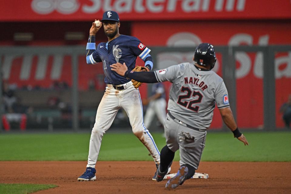 Kansas City Royals second baseman Maikel Garcia (11) throws to first base for a double play after forcing out Cleveland Guardians' Josh Naylor (22) in the third inning Friday in Kansas City, Missouri.