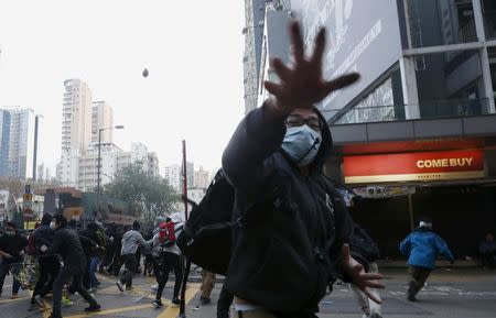 Protesters throw bricks during a clash with riot police at Mongkok district in Hong Kong, China February 9, 2016. REUTERS/Bobby Yip