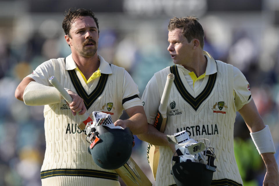 Australia's Travis Head, left and teammate Australia's Steven Smith walk off the pitch together after the end of play on the first day of the ICC World Test Championship Final between India and Australia at The Oval cricket ground in London, Wednesday, June 7, 2023. (AP Photo/Kirsty Wigglesworth)