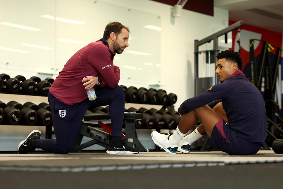 BURTON UPON TRENT, ENGLAND - MARCH 20: Gareth Southgate, Manager of England men's senior team, talks to Ollie Watkins of England in the gym at St George's Park on March 20, 2024 in Burton upon Trent, England.  (Photo by Eddie Keogh - The FA/The FA via Getty Images)