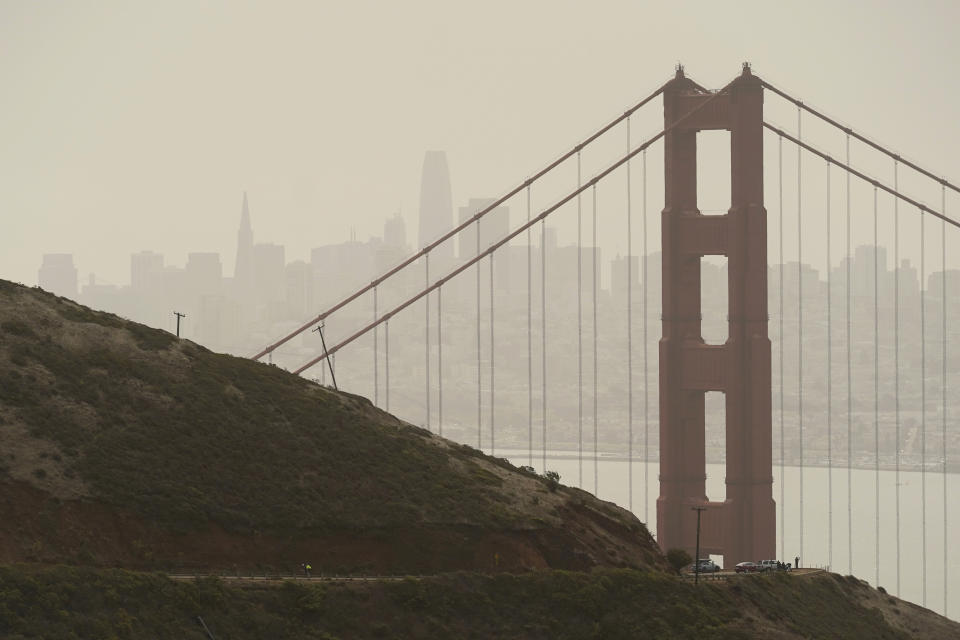 Smoke and haze from wildfires obscure the Golden Gate Bridge and San Francisco skyline in the background near Sausalito, Calif., Wednesday, Aug. 18, 2021. Wind-driven wildfires raged Wednesday through drought-stricken forests in the mountains of Northern California after incinerating hundreds of homes and forcing thousands of people to flee to safety. (AP Photo/Eric Risberg)