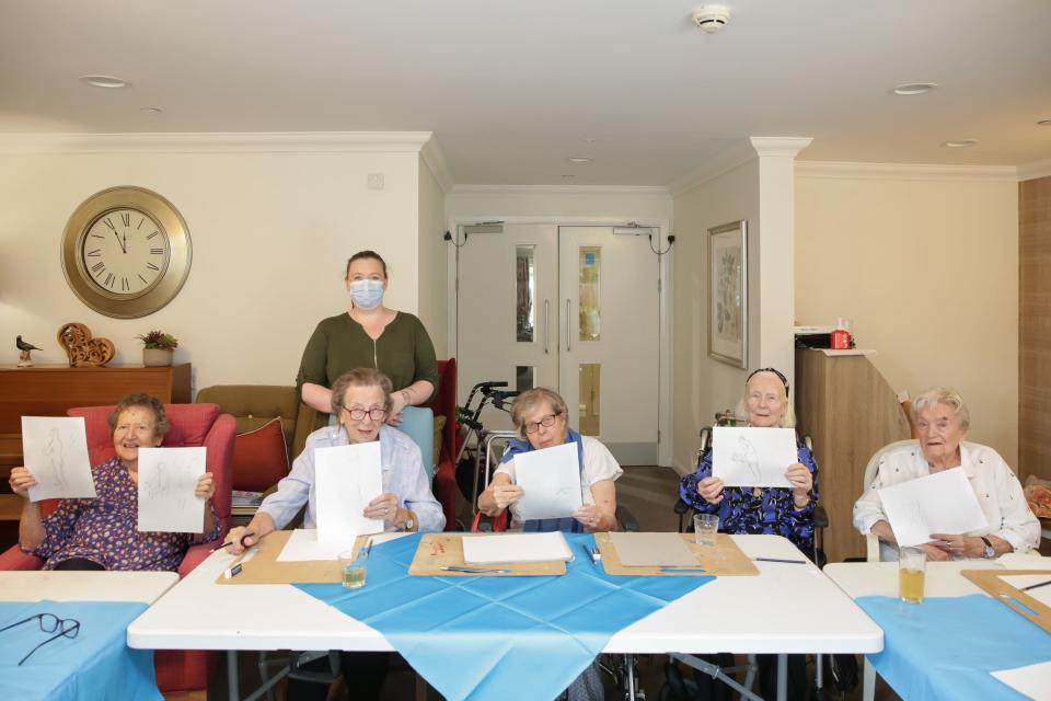 Residents with their artwork (Andrew Williams/Care UK/PA)
